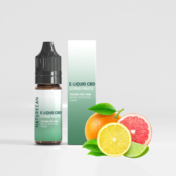 Caja y bote E-Liquid CBD 1000mg junto a frutas